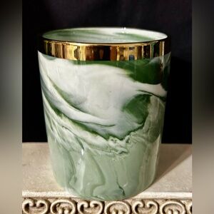 Green marble, ceramic holder or cup with gold rim.